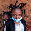 3500.jpgMartha Apisa, 12, and Stacy Ayuma, 8, pose for a photograph outside their house after plaiting their hair with a style designed to emulate the prickly appearance of the Covid-19 virus..jpg